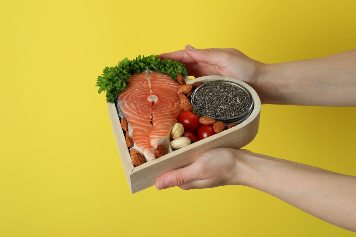 Female hands hold healthy food on yellow background