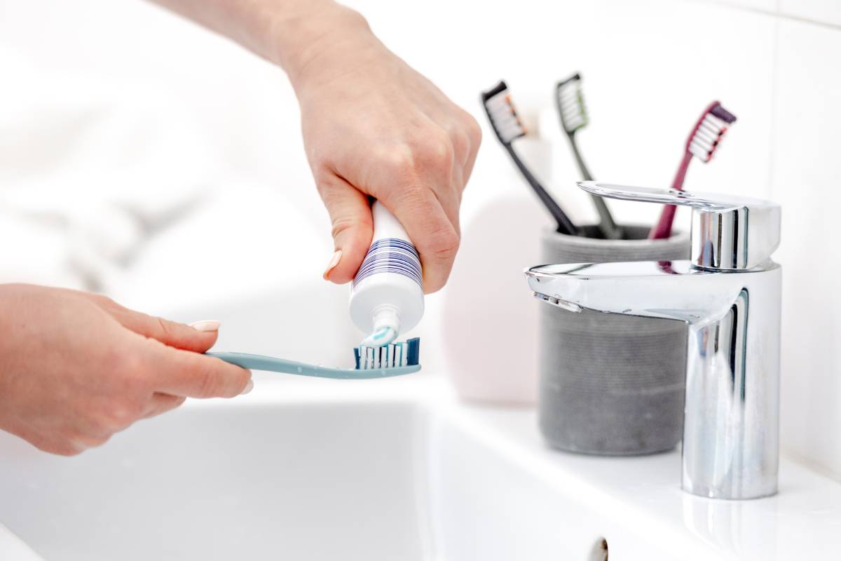 girl-s-hand-applies-toothpaste-to-brush-2024-03-05-15-28-15-utc (1)