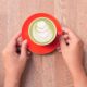 matcha latte in a red color cup on table