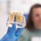 close-up patient dental implant treatment plan. The focus is teeth implant model in dentists hand