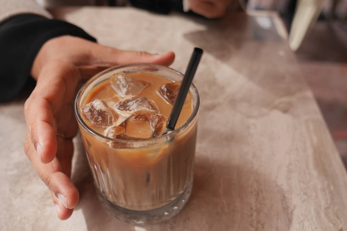 Enjoying ice coffee at a cozy cafe during a warm afternoon